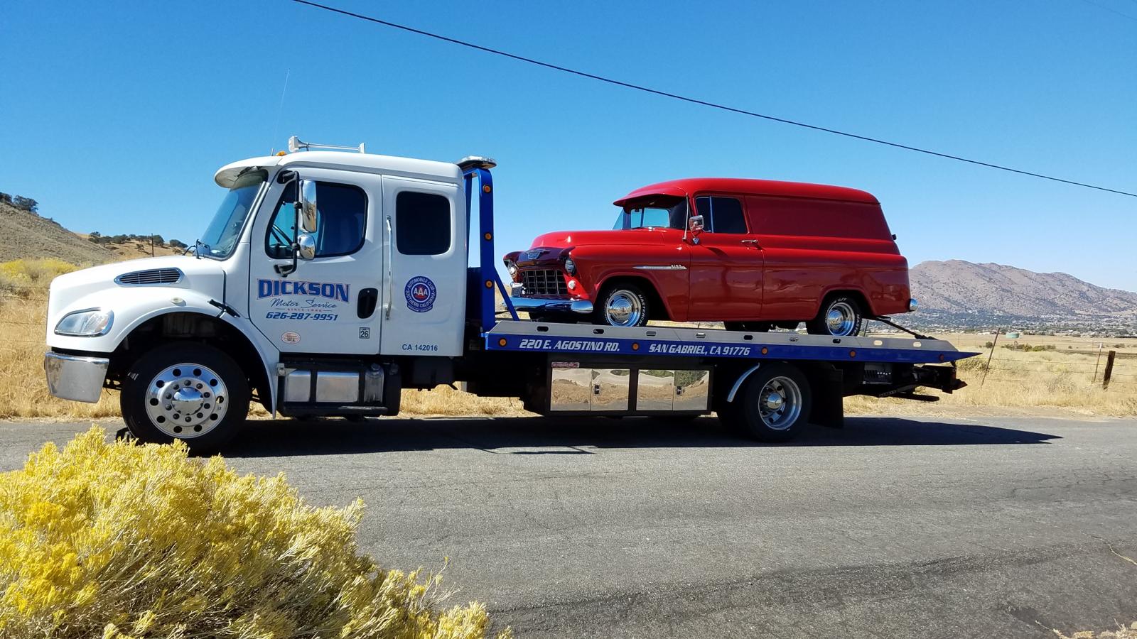 Dickson Motor Service flatbed transporting a red 1955 Chevy panel van