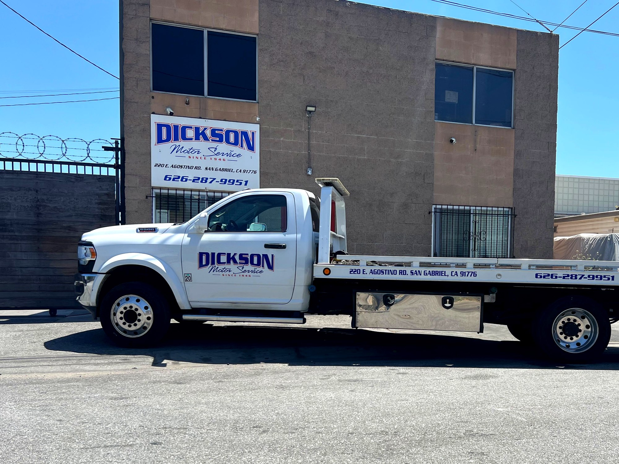 Dickson Motor Service flatbed tow truck in front of our San Gabriel facility at 220 E Agostino Rd